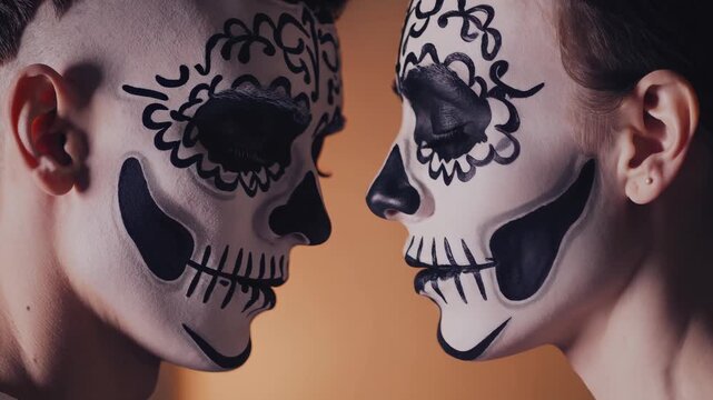 Intimate close-up of two adults with complementary skull makeup sharing a quiet, tender moment, foreheads gently touching, eyes closed, Day of the Dead inspired couple portrait