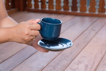 woman hand holding a cup of coffee