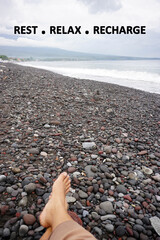 Inspirational motivational quote - Rest, relax and recharge. With legs of person on beach. Healing...