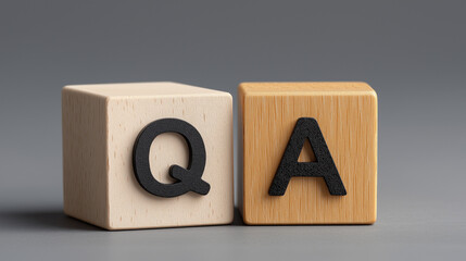 Q and A Concept with Wooden Cube Blocks on Grey Background