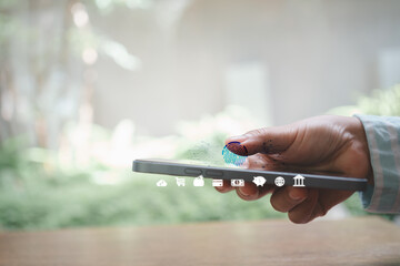Hand using smartphone with biometric fingerprint scan for secure mobile payments, digital identity,...