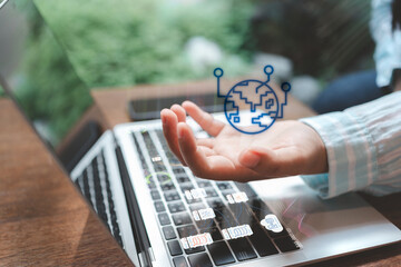 Open hand over laptop with holographic globe and data-flow icons; concept of global network, data integration, cloud computing, and AI-driven analytics