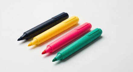 Fototapeta premium Four colorful highlighters diagonally arranged on a white surface