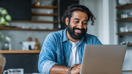 Obraz premium smiling bearded indian businessman working on laptop at home office young indian student using computer remote studying virtual training on video call meeting watching online webinar or seminar no lo