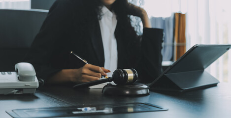 Judge gavel with Justice lawyers having team meeting at law firm background. Concepts of Law and Legal services.