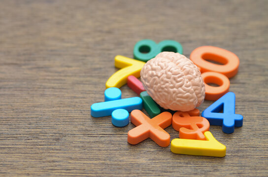A human brain model surrounded by colorful numbers and symbols, representing cognitive function, calculation, and logical reasoning.