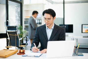 Asian business team and lawyers discussing contract papers sitting at the table. Concepts of law, advice, legal services.