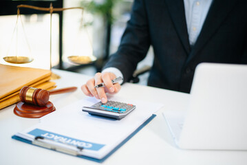 justice and law concept.businessman or lawyer or accountant working on accounts using a smart phone...