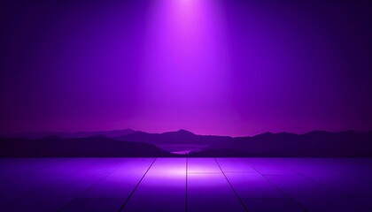Purple stage lit by spotlight, mountains in background