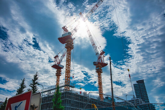 A cityscape of moving crane and cloud at the under construction wide shot
