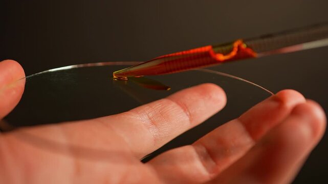 LSD in liquid dropped from pipette to glass. Also named Acid, lucy, or Ellis D. Semisynthetic hallucinogenic drug made of ergot fungi. Demonstration of Lysergic acid diethylamide known as LSD.