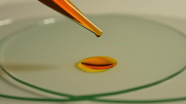 LSD in liquid dropped from pipette to glass. Also named Acid, lucy, or Ellis D. Semisynthetic hallucinogenic drug made of ergot fungi. Demonstration of Lysergic acid diethylamide known as LSD.