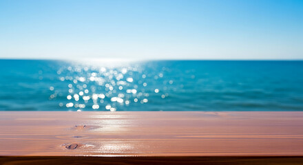 Wood table top with blurred sparkling sea water and bright summer sky background. Tropical beach concept