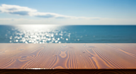 Wood table top with blurred sparkling sea water and bright summer sky background. Tropical beach concept