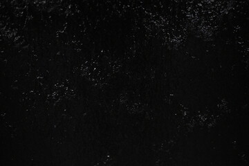 Black background, created by water flowing from the top, black wall as a waterfall.