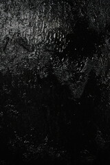 Black background, created by water flowing from the top, black wall as a waterfall.