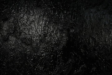 Black background, created by water flowing from the top, black wall as a waterfall.