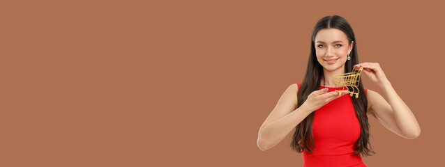 A woman showcases a gold shopping cart while smiling