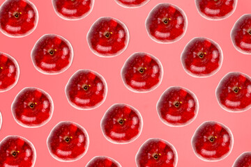 Vibrant red apples form a seamless repeating pattern against a monochromatic pink background.