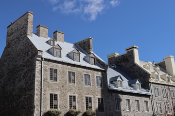Fototapeta premium A view in summer of the Old Quebec in Canada with ancient architecture. Ancient building with stone facade and old building renovated . Historic building in Royale Place in Quebec city in Canada.