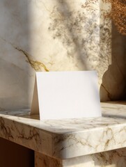 elegant blank card resting on a marble table with soft sunlight