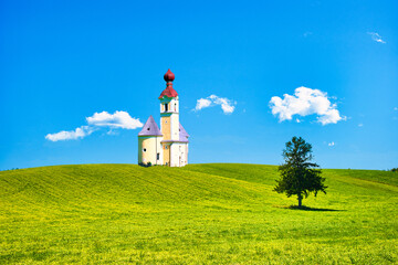 丘にたつ一本の木とヨーロッパ風教会合成写真