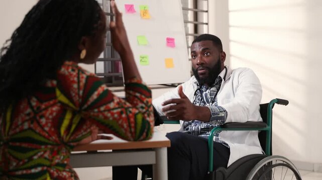 African doctor in a wheelchair consults with a female patient, inclusion and attentive care in a professional office setting