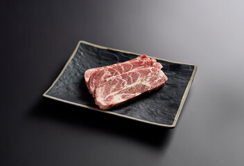 raw pork belly on a plate