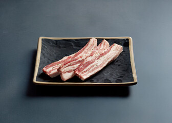 raw pork belly on a plate