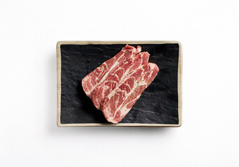 raw pork belly on a plate