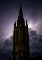 Obraz premium Dark Gothic Church Tower Silhouette Against a Stormy Night Sky