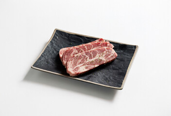 raw pork belly on a plate