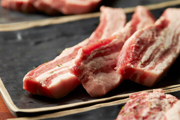 raw pork belly on a plate