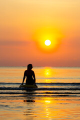 Fototapeta premium Woman with sunrise and silhouette