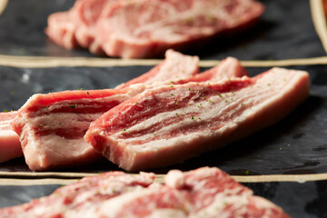 raw pork belly on a plate