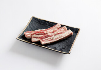 raw pork belly on a plate