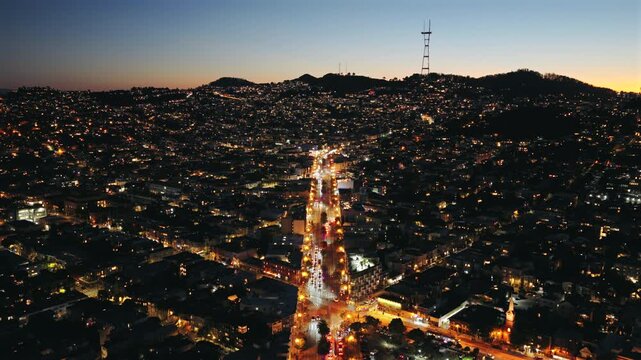 San Francisco - Aerial Approach Over Market St Facing West at Night with Glowing Lights and Sutro Tower