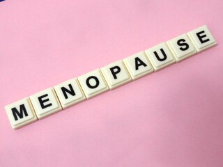 Menopause word written on tiles block. Concept