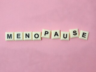 Menopause word written on tiles block. Concept.