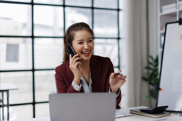 Office, business asian woman and laptop with phone call for communication, financial help or bank reconciliation. Career or accountant with mobile for finance talking, account info or contact
