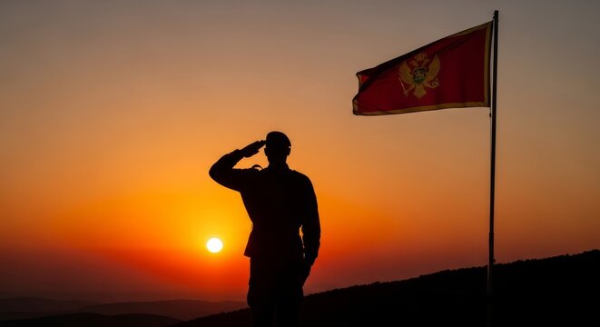Soldier silhouette saluting at dramatic sunset,  Montenegro flag waving in the wind, patriotic holiday tribute, powerful symbolic scene