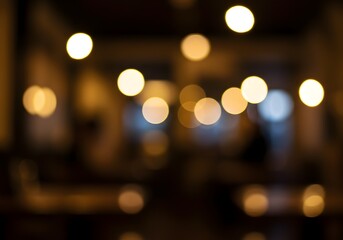 Soft focus visual effect of glowing golden orbs of light creating a beautiful bokeh pattern against a dark background