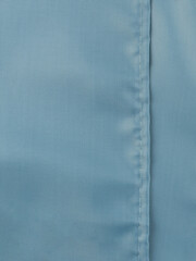 a neat seam on the light blue polyester material