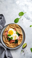 Savory crepe with eggs, ham, and spinach