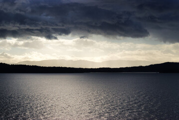 sunlight breaking through dark storm clouds