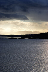 sunlight breaking through dark storm clouds