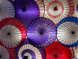 A Dense Collection of Traditional Japanese Paper Umbrellas Showcasing Rich Color and Light Transmitting Texture