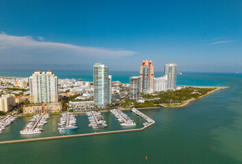 Yacht docked at Miami marina. Aerial view of coastline in Miami. Sailboat cruising along the Miamis...