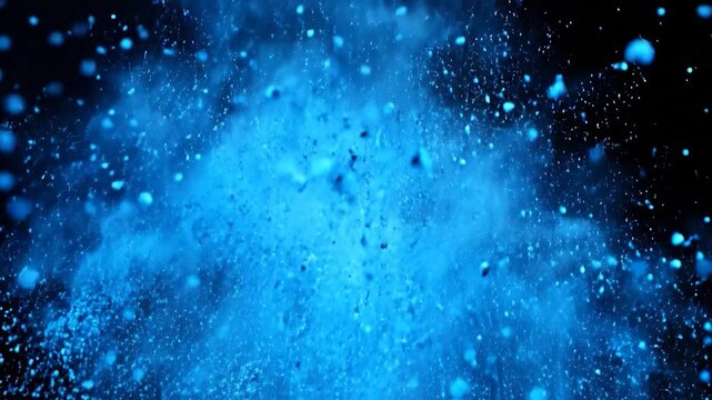 A vivid blue powder explosion erupts, scattering countless particles and smoke across a dark background