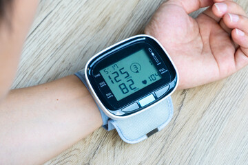 Woman check blood pressure monitor and heart rate monitor with digital pressure gauge. Health care...